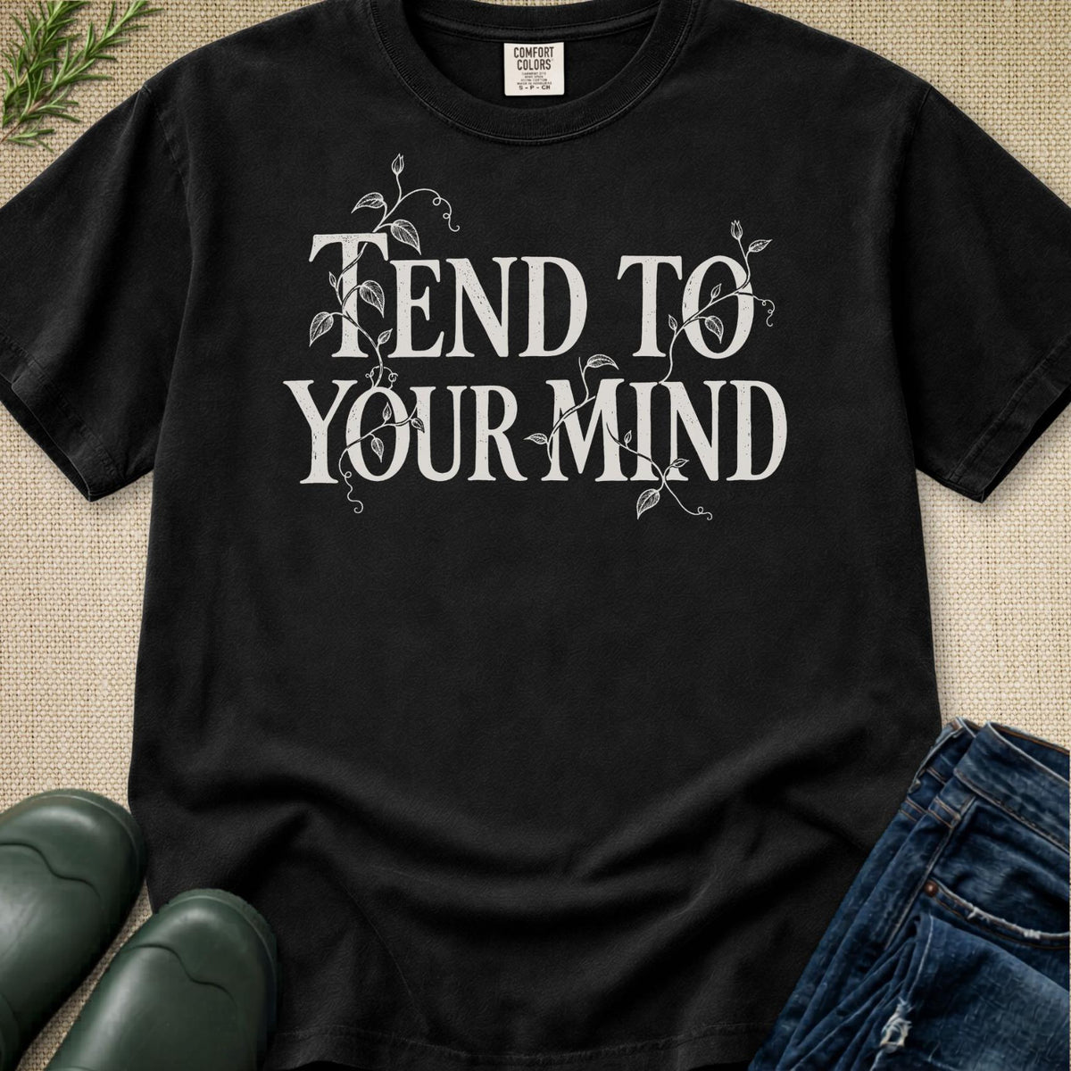 Black t shirt reading 'tend to your mind' with tendrils of climbing plant winding through the words